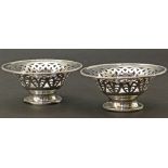 A pair of silver bonbon dishes by Walker & Hall, pierced decoration on pedestal feet, gross weight