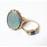 Two 9ct gold dress rings, one set with blue and white stones, one with opal simulant Conditions