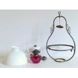 A Victorian ruby glass hanging lamp with shades and an embossed table lamp Conditions reports are