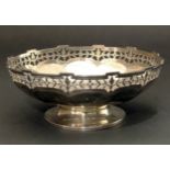 A small faceted silver dish on pedestal with pierced decoration border, marks for Aidie Brothers,