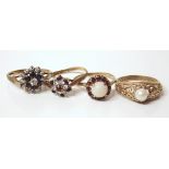 Four 9ct gold dress rings, one set with cultured pearl, one imitation opal red stone, one red and