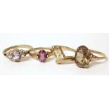 Four 9ct  gold dress rings, one smokey quartz set, one three-stone amethyst, one set with purple