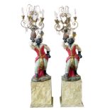 Two painted plaster Blackamoor figural floor lights on simulated marble bases. Condition reports are