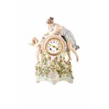 A 19th century Sitzendorf mantle clock. With figure of woman and cherub child standing atop a