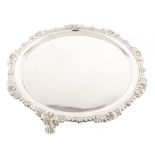 George IV circular silver salver , plain polished with acanthus leaf scrolling border on three paw