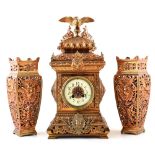 A 19th century French brass fretted mantle clock and garnitures. The brass caddy-top case and