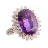 Amethyst and diamond cluster 18ct white gold ring , central oval mixed cut amethyst measuring