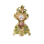 A late 19th century French porcelain mantle clock. With scroll outline detail framing painted floral