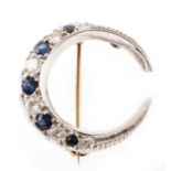 Sapphire and diamond white gold crescent-shaped brooch , comprising alternating mixed cut
