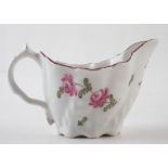 Lowestoft low Chelsea ewer circa 1775, painted with a rose spray in polychrome enamels, 9.5cm long