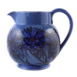 Moorcroft jug, decorated with corn flower on a powder blue ground. 17.5cm high For a condition