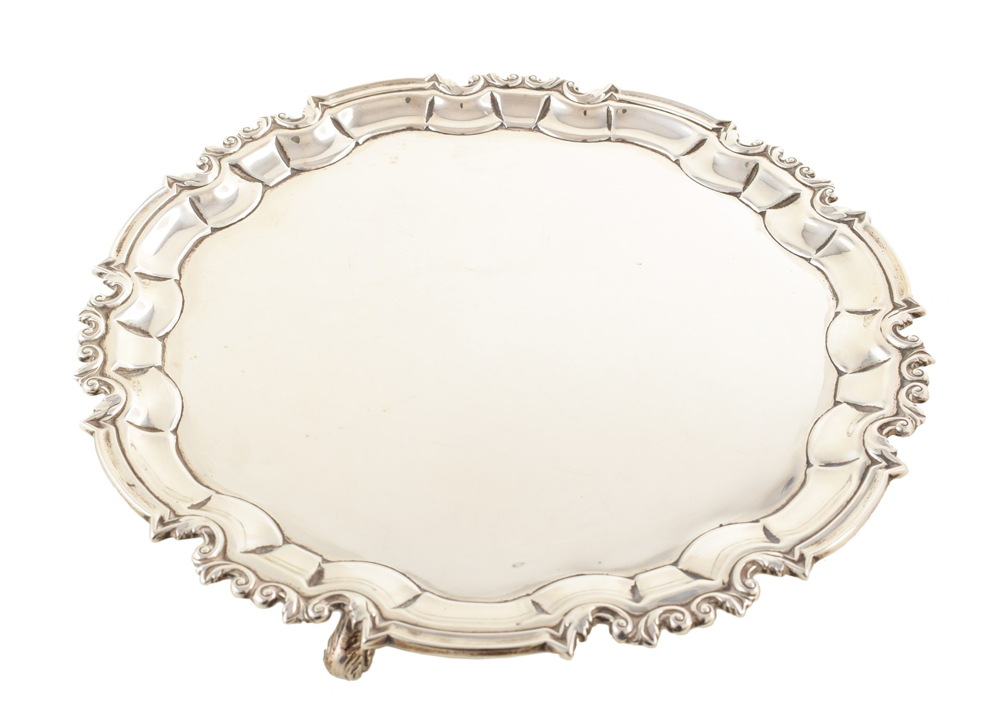 Circular silver salver by William Hutton & Sons , plain polished with chippendale border on 3