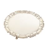 Circular silver salver by William Hutton & Sons , plain polished with chippendale border on 3