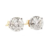 Pair of diamond solitaire 18ct gold stud earrings , the two round brilliant cut diamonds 4-claw