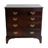 George III mahogany chest of four long graduated drawers, fitted brushing slide, replacement brass