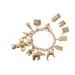 9ct gold charm bracelet with assorted charms , curb link bracelet with safety chain and heart shaped