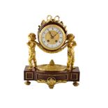 A late 19th century Scottish mahogany and gilded bronze mantle clock. A pair of bronze putti hold