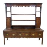 George III oak and mahogany cross-banded dresser, top section with fretwork cornice, three fixed