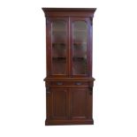 Victorian mahogany bookcase on cupboard, top with two single panel glazed doors covering three