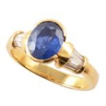Sapphire single stone 18ct yellow gold ring with diamond set shoulders , central oval brilliant