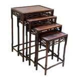 Early 20th century rosewood nest of four tables, each with rectangular top, fretwork frieze,