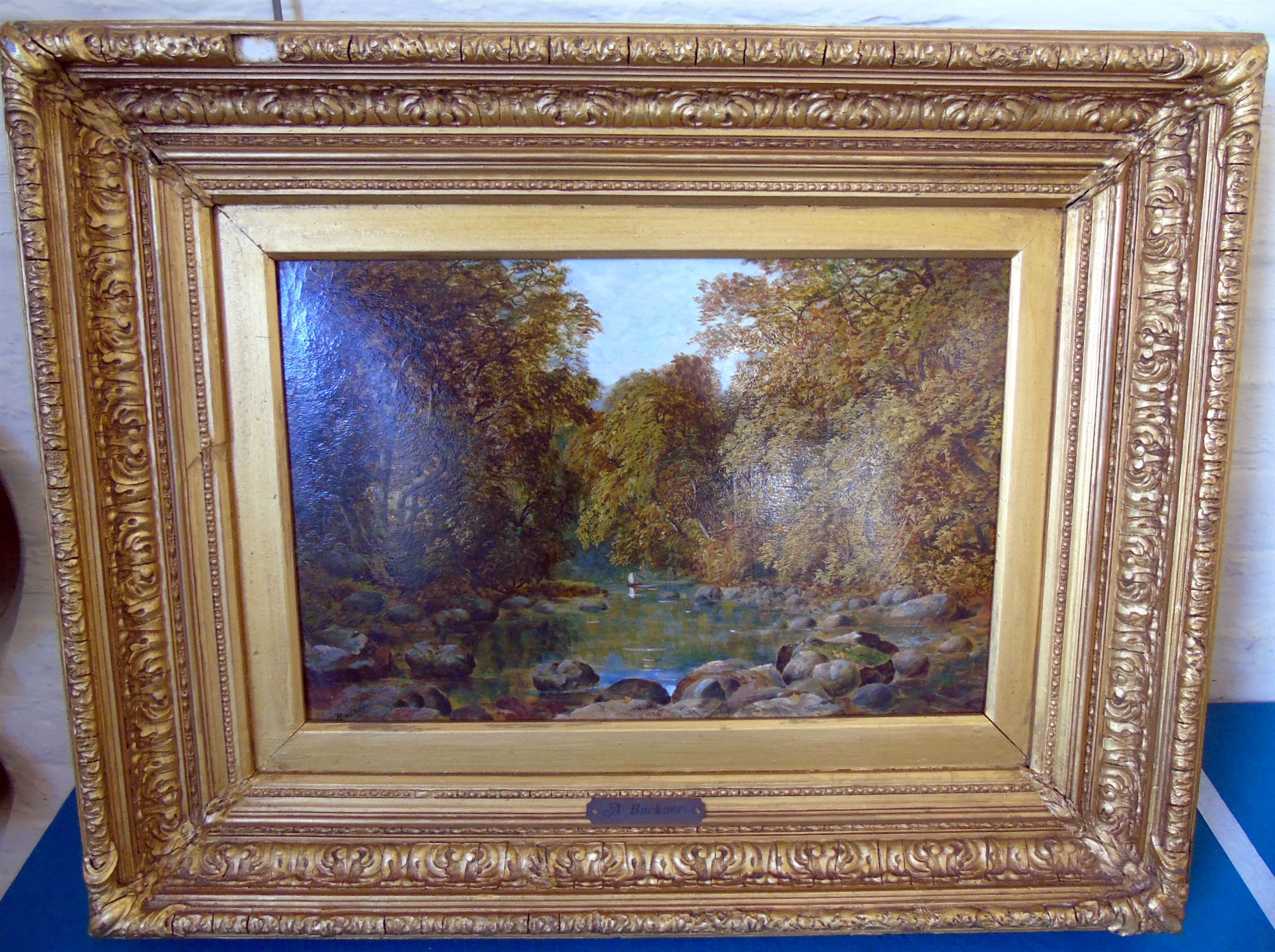 Gilt framed oil on board of tranquil wooded river scene by A. Buckner. Condition reports are not