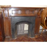 Early 20th century oak fire surround with cast iron arched insert, 146cm wide. Condition reports are
