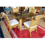 Kiani cane dining table and four chairs, the table having smoke glass top. Condition reports are not