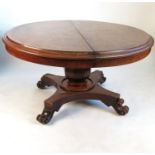 A 19th century circular pull-out extending dining table,