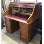 A late 19th century oak roll top desk, fitted with drawers,