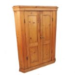 A 19th century pine double door corner cupboard, opening to reveal shelves, width 37ins,