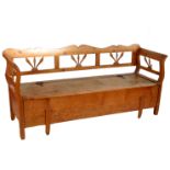 A pine window seat, with galleried back, the box seat having rising lid,