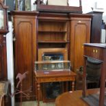 A 19th century mahogany inverted break front wardrobe, fitted centrally with drawers,