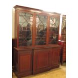 A 19th century break front bookcase, with glazed upper section, fitted panelled doors to the base,