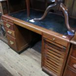 An oak desk, fitted frieze drawers, over two banks of three drawers, with Glasgow label,