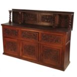 A 19th carved oak dresser base, with four carved panels, over three drawers and cupboards,