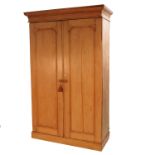 A 19th pine wardrobe, having two twin panelled doors, opening to reveal hanging space,