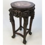 A hardwood, possibly padouk, jardiniere stand, inset with marble top, height 24ins,