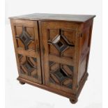 A 19th century oak cupboard, with 17th century style geometric moulded front cupboard doors,