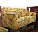 A Greensmith's Abbey three seater curved sofa, in floral upholstery,