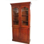 A 19th century pitch pine bookcase cupboard,