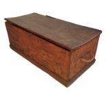 A 19th century elm coffer/box, with rising lid, raised on plinth base,