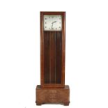 A walnut cased Art Deco longcase clock, having square dial,