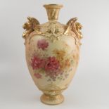 A Royal Worcester blush ivory vase, decorated with flowers, with gilt griffin mask handles,