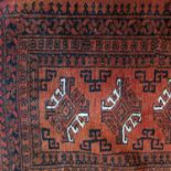 An Oriental runner, the orange ground decorated with hooked motifs to field, 120ins x 30.