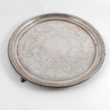 A silver circular tray, with bead edge,