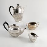 A silver four piece tea set, with gadrooned lower body, engraved with initials, Birmingham 1897,