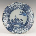 A Kraak porcelain dish, decorated with central landscape, with alternate panels of foliage,