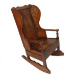 An Antique elm lambing chair, fitted with a side drawer to the box seat,