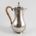 A silver hot water jug, of baluster form, with wicker insulated handle, engraved with a monogram,